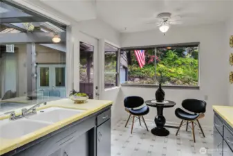 Eating space in kitchen with view to front rockery & landscaping.