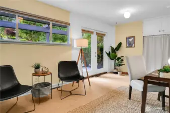 A transitional space.  Originally third bedroom or could be office/den combination.  French doors open to patio and water feature.