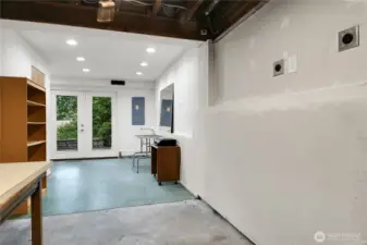 Utility room on lower level with double doors to patio and backyard.