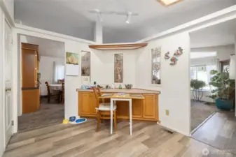 The breakfast nook in the kitchen, with the dining room visible to the left and living room on right.