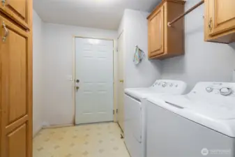 Big laundry room with storage and drying rack.