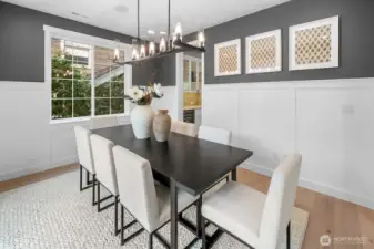 Formal dining space with abundant natural light and contemporary finishes. Open sight lines provide a seamless connection to the kitchen and living areas.