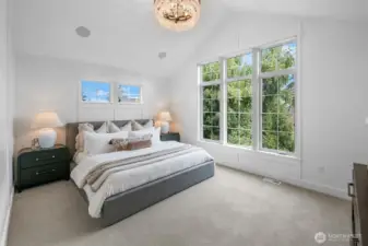 Vaulted primary suite with oversized windows, designer chandelier, and serene treetop outlooks. A private retreat filled with natural light.