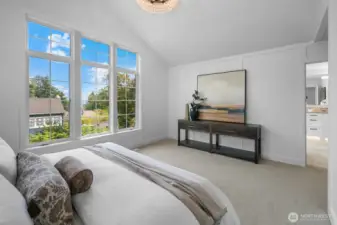 Panoramic windows in the primary suite bring the outdoors in, creating a serene and light-filled sanctuary.