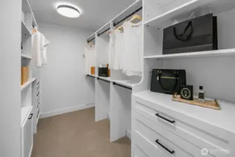 Custom closet system with dual hanging space, shelving, and drawer storage. Designed to maximize organization and style.