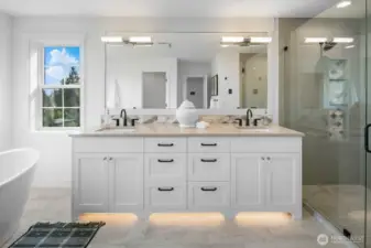 Luxurious primary bath with dual vanities, quartz counters, designer lighting, and full-height mirror. Elegant finishes create a spa-like retreat.