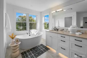 Freestanding soaking tub framed by picture windows, offering abundant natural light and serene treetop views. A perfect place to unwind.