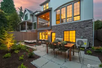 Expansive backyard patio with built-in seating, dining area, and garden landscaping. A seamless extension of the home’s living space.