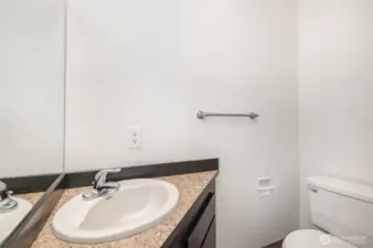 Hallway half bath for guests.