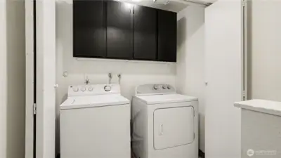 Upstairs laundry with storage for convenance.