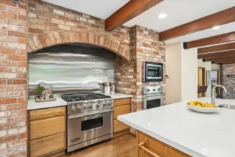 New quartz counters and stainless backsplash with Viking Stove and oven