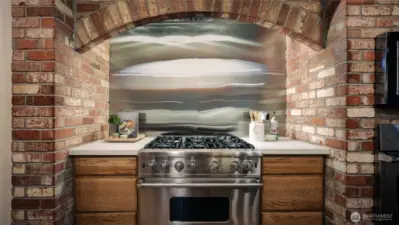 New quartz counters and stainless backsplash with Viking Stove and oven