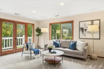 Sitting area and private balcony off of primary bedroom