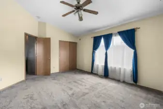 A spacious primary bedroom with room to relax and unwind