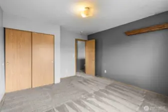 A comfortable secondary bedroom with great natural light and closet space