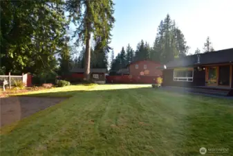 Mature and manicured level backyard that is fully fenced and adorned with beautiful plants and flowers that will bloom from early Spring to late Fall.