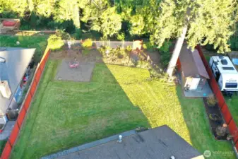 Backyard extends into the trees.