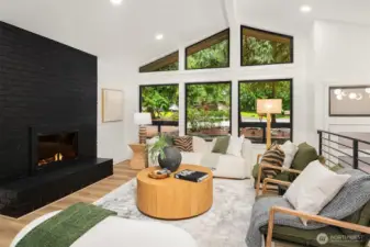 Floor to ceiling gas fireplace anchors the living space.