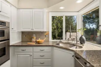 Granite counters with full-height backsplash.