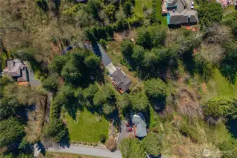 Tucked back on over an acre of lush evergreens.