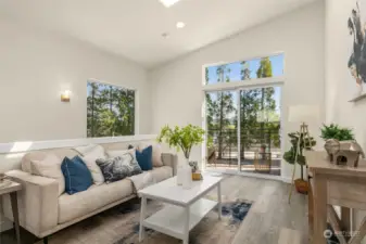 Experience the beauty of natural light and a spacious atmosphere in our stunning living space featuring vaulted ceilings and large windows, the perfect combination for a bright and inviting room that you'll love spending time in.