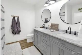 The en suite features double vanities and a shower.