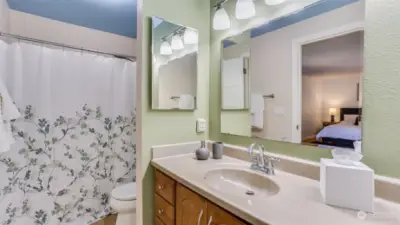 Spacious primary bathroom with large mirrors, ideal for getting ready with ease.