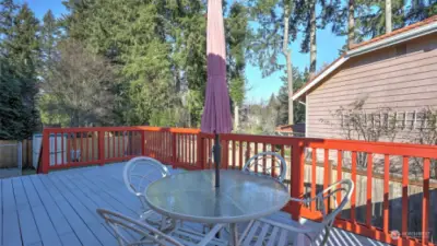 Spacious deck with a dining area, perfect for entertaining guests and enjoying outdoor gatherings