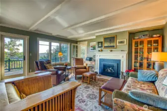 This view shows the new fireplace insert and door to the deck. Note: all furnishings are negotiable.