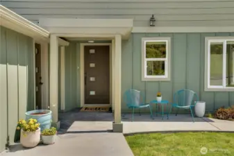 The front door enhances the modern aesthetic. The door to the garage provides convenient access to the front entrance, while an interior connection from garage to the lower level offers additional entry to the home.