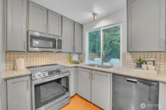 kitcheUpdated kitchen on the main floor includes upgraded appliances, painted cabinets, and stone countertops. n3