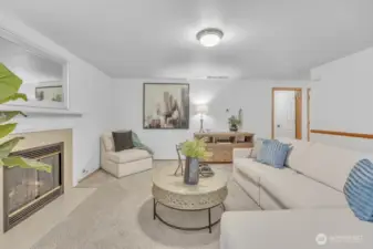 Large living space on the main floor with gas fireplace and views of the private back yard.