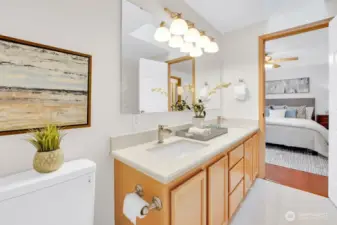 Primary en-suite features upgraded fixtures, stone slab countertops, and lots of natural light.
