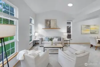 Large formal living room off the entrance with several windows.