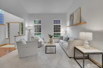 Large formal living room off the entrance with several windows.