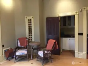 Small sitting area, built in wine rack and one of two pantries in the kitchen.