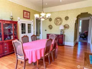 Handy built in cabinet for dining and serving implements in the formal dining room. Decorative archway leading to library/main floor en-suite bedroom.