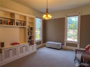 This large room boasts a walk-in closet and full bathroom to the right of the photo frame abounds with versatility...main floor en-suite bedroom, library, family, game or music room, you choose.