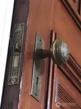 Detailed vintage Victorian hardware adorn the solid wood doors.