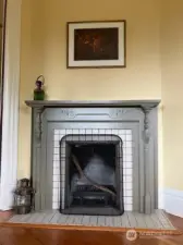 Living room anchored by a decorative fireplace.
