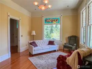 Stained glass embellishment in the living room with doorway to the hallway and front door.