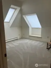 Room with 2 skylights at the top the staircase.