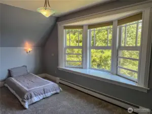 One of two other upstairs bedrooms with a bay window, built-in desk and walk-in closet.
