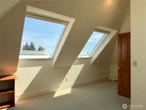 Three skylights enhance the light energy in the 3rd floor room.