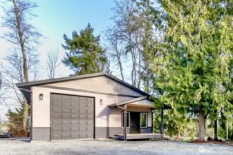 Front view of detached shop nestled in the trees.