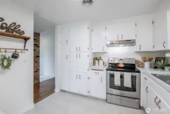 Refreshed yet charming kitchen with dainty details like copper hardware,