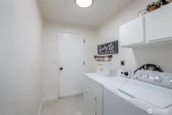 Laundry room off garage and hallway features new Duralux flooring.