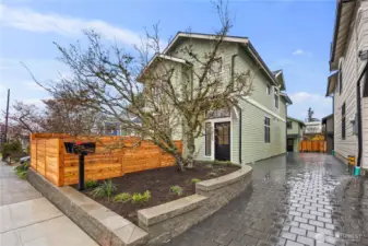 Private driveway leads to garage loaded from back of home.  When this cherry tree blooms, its spectacular!