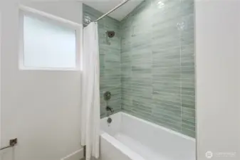 Guest bathroom with cool tiles and extra deep soaking tub