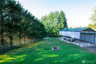 Lovely fenced extension of backyard w/ fire pit
